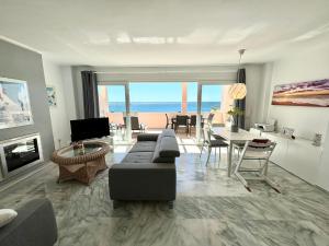 a living room with a view of the ocean at Diletta Beach Estepona in Estepona