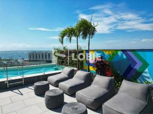 a patio with chairs and a swimming pool on a building at Lobie Skylux in Rio de Janeiro