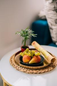 a plate of fruit and vegetables on a table at LUXURY STUDIO in Veliko Tŭrnovo