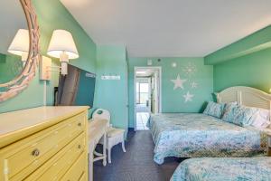 a hotel room with two beds and a mirror at Myrtle Beach Oceanfront Condo w/ Pool & Lazy River in Myrtle Beach +19 photos