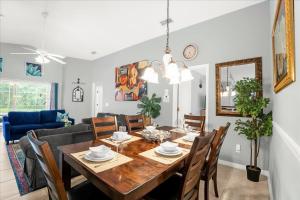 a dining room and living room with a table and chairs at Upstay Lakeside Retreat w Private Pool and Game Room in Davenport