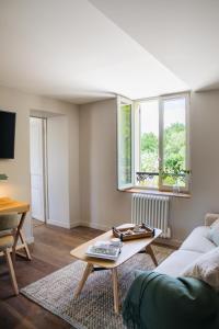 a living room with a couch and a table at Domaine les Bruyères in Gambais