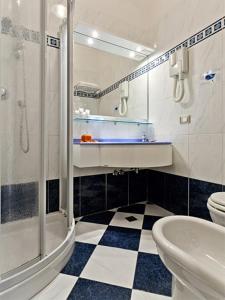 a bathroom with a shower and a sink and a toilet at Hotel Sorriso in Lido di Classe