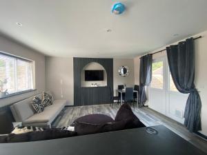 a living room with a couch and a table at Rivendell spacious two bedroom 1st floor flat in Kent