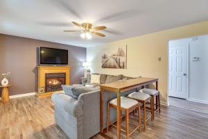 a living room with a couch and a table and a fireplace at 7 Mi to Big Boulder Resort-Style Poconos Retreat in Albrightsville
