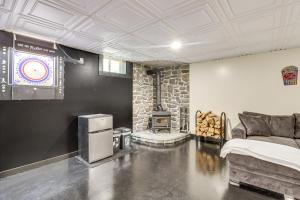 a room with a fireplace and a bed and a couch at 7 Mi to Big Boulder Resort-Style Poconos Retreat in Albrightsville +29 photos