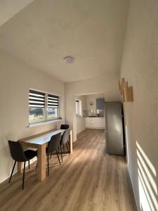 a kitchen and dining room with a table and chairs at Penzión Stratenka in Stratená