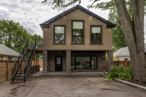 a house with a staircase in front of it at Lake House By Lis in Innisfil