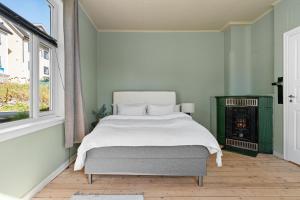 a bedroom with a bed and a fire place at Historical villa in the city center in Tromsø