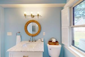 a bathroom with a sink and a mirror at Osprey's Nest in West Hyannisport +30 photos