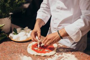 a chef is making a pizza on a counter at InterContinental Genève by IHG in Geneva