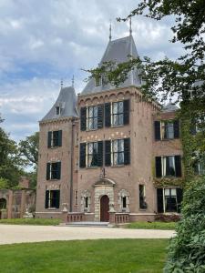 a large brick building with a roof at Bed & Breakfast Danina in Sassenheim