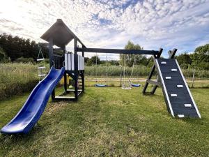 a playground with a slide at Domki Nadmorska fala Rusinowo in Rusinowo