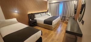 Cama ou camas em um quarto em Hotel Canal Beagle
