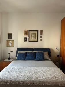 a bedroom with a large bed with blue pillows at Ketty's House in Vico Equense