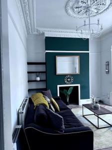 a living room with a couch and a fireplace at Blessed Princess House With Free Parking in Sunderland