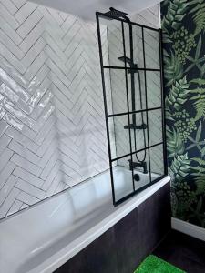 a bathroom with a mirror and a bath tub at Blessed Princess House With Free Parking in Sunderland