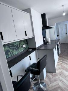a kitchen with two chairs and a counter top at Blessed Princess House With Free Parking in Sunderland