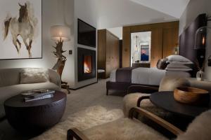 a hotel room with a bed and a fireplace at Hotel Yellowstone at Jackson Hole in Jackson