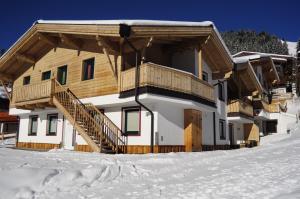 a house in the snow with a balcony at Chalet Central Top CC 8 in Königsleiten