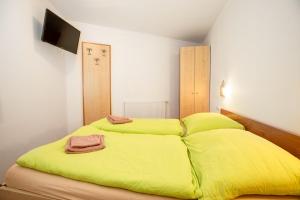 a bedroom with two beds with lime green sheets at Chalet Central Top CC 6 in Königsleiten