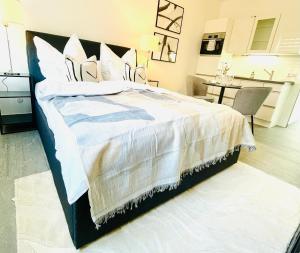 a bedroom with a large bed with white sheets and pillows at Innerste City Getaway in Goslar