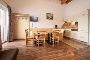 a kitchen with a wooden table and chairs at Chalet Central Top CC 7 in Königsleiten