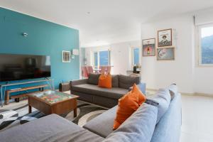 a living room with a couch and a table at Luxury Villa Laglio in Laglio