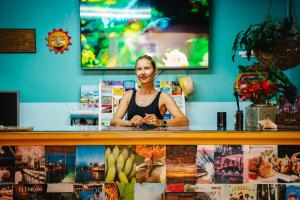 a woman standing behind a counter in a store at Coconut Court Beach Hotel in Bridgetown