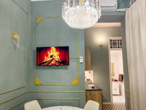 a room with a painting of a fire on the wall at Apartamentos Loles De Cisneros Catedral in Málaga