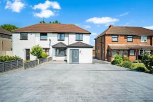a large white house with a driveway at Family Contractors 3 bed house free parking sleeps7 in Bilston