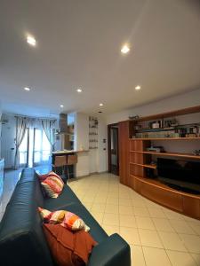 a living room with a couch and a television at Ketty's House in Vico Equense