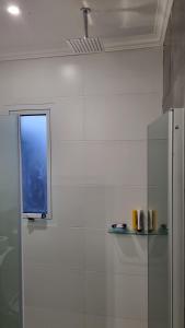 a white kitchen with a window on the wall at Velvet Apart in Esperanza