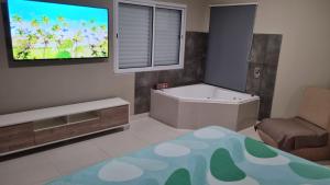 a rendering of a bathroom with a tub and a tv at Velvet Apart in Esperanza