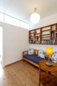 a bedroom with a bed and a table and shelves at Appartamento Capodilucca in Bologna