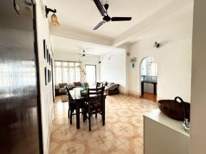 a living room with a table and chairs in it at La Belleza Guesthouse in Guwahati