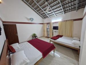 Un pat sau paturi într-o cameră la Kattegadde Homestay - Swimming Pool and Rooms with Private Balcony By Dazzle Destinations