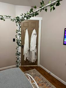 a room with a door with white clothes at Garden Whisper Cozy Chamber in Cleveland +9 photos