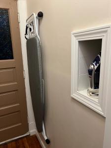 a room with a door with a mirror and a gun at Garden Whisper Cozy Chamber in Cleveland