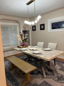 a dining room with a wooden table and chairs at Garden Whisper Cozy Chamber in Cleveland