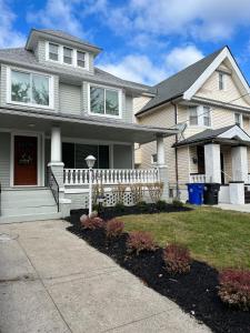 a house with a white fence in the front yard at Garden Whisper Cozy Chamber in Cleveland
