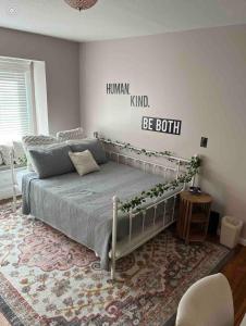 a bedroom with a bed with a sign on the wall at Stained Glass Serenity Suite in Cleveland