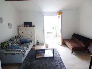 a living room with a couch and a coffee table at studio calme entre Montpellier et la mer in Saussan