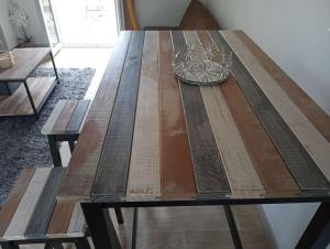 a wooden table with a bowl on top of it at studio calme entre Montpellier et la mer in Saussan
