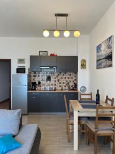 a kitchen and a dining room with a table and a kitchen at Apartments Mediterano in Senj