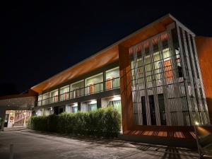a building at night with its lights on at เดอเนส บูติก โฮมสเตย์ C9 Denest Boutique Homestay in Ban Phai