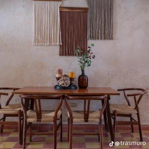a dining room table with chairs and a vase on it at Itinerante/Casa del Mago. Mérida in Mérida +40 photos