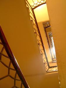 a room with a yellow wall and a ladder at Hotel Cestelli in Florence