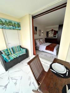 ein Schlafzimmer mit einem Bett, einer Couch und einem Tisch in der Unterkunft Studio sunshine vue mer et piscine in Tartane + 22 Fotos