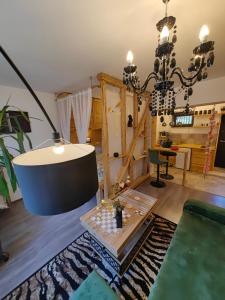 a living room with a table and a chandelier at Casa Anne Boutique in Braşov +122 photos